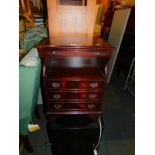 A reproduction mahogany bedside chest, with brushing slide and drawer fronted cupboard, 65cm high,