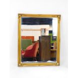 A rectangular gilt wood wall mirror, inset bevelled glass, 106cm high, 128cm wide.