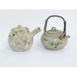 A Japanese early 20thC ceramic teapot, enamel decorated in relief with birds and flowers, two