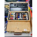 A pine paint box cum easel, containing a pallet, paints and brushes, book, etc., and a further box