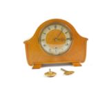 An Empire oak cased mantel clock, eight day movement with Westminster chimes, with key, 23cm high,