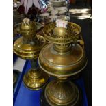 Two brass oil lamps, Paris porcelain oil lamp base, three glasses chimneys, wicker shade, and two