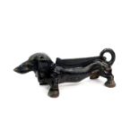 A cast iron boot scraper, modelled as a Dachshund, 35.5cm wide.