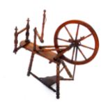 A 19thC oak spinning wheel, 91cm wide.