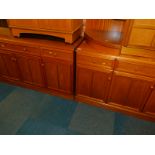 A pair of Stag teak sideboards, each with three drawers above four cupboard doors, 78cm high,