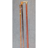 A malacca cane with a metal knop, ebonised and marquetry walking cane, and a walking stick with a