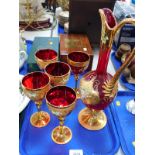 A Venetian ruby and gilt glass wine jug, and five wine glasses, enamel decorated with flowers. (1