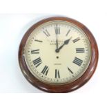 An early 20thC oak cased wall clock by F L Hill, Brierley Hill, For Garrard, 39cm diameter.