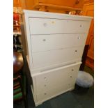 A pair of white melamine chests of three drawers, raised on bracket feet, 74cm high, 90cm wide, 46cm