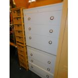 A pair of white melamine three drawer chests, each 78cm high, 75cm wide, 40cm deep, together with
