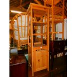 A pine bathroom shelving unit, with lower cupboard, 144cm high, 40cm wide, 40cm deep.