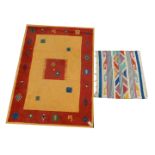 A modern rug, beige ground, 174cm x 121cm, together with a small Kelim rug, 83cm x 72cm. (2)