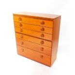 A Meredew teak chest, of seven long graduated drawers, raised on a plinth base, 113cm high, 102cm