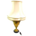 A French early 20thC brass table lamp, of twin griffin's head and ring handled form, with engraved