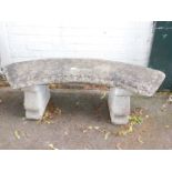 A reconstituted stone bench, with carved seat and scrolled pedestals.