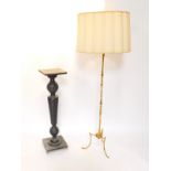 A brass standard lamp, raised on slender brass legs, 160cm high., together with a black painted