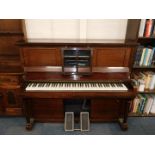 An Eavestaff mahogany cased pianola, together with approximately 145 pianola rolls.