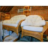 A bamboo and wicker three piece conservatory suite, comprising sofa and two armchairs.
