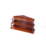 A Victorian mahogany wall mounted waterfall bookcase, of three shelves raised on S scroll