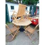 A teak octagonal garden table, together with six folding chairs including two carvers. (7)