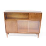 A Nathan teak sideboard, with an arrangement of cupboard doors and glazed sliding doors, raised on