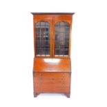 An Edwardian mahogany and satinwood cross banded bureau bookcase, the outswept pediment over base