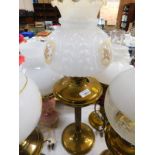 A brass fluted column oil lamp, with chimney and moulded white glass shade with reserve panels of
