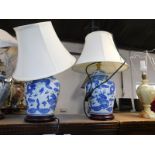 A pair of Chinese porcelain vase and cover table lamps, printed with dragons, with white shades,