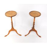 A pair of mahogany wine tables, with central turned columns raised on pad feet, each 57cm high. (2)