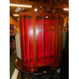 A mid 20thC figured walnut bow front display cabinet, 114cm high, 102cm wide, 41cm deep.