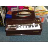 A Magnus electric chord organ, brown Bakelite cased.