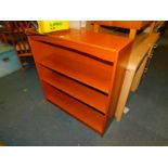 A teak bookcase, enclosing two adjustable shelves, 95cm high, 90cm wide, 28cm deep.