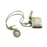 A George V silver vesta case, foliate engraved, with monogram reserve, Birmingham 1912, on a chain