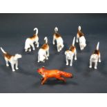 A Beswick figure of a fox, together with seven hounds.