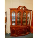 A mahogany dining room china display cabinet, of canted bow front with four glazed doors, above