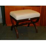 A reproduction mahogany X frame stool, with turned stretcher and upholstered in cream cotton fabric,