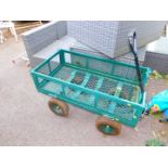 A green painted steel and wire mesh dog cart.
