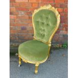 A Victorian gilt gesso spoon back nursing chair, with green draylon upholstery, raised on turned