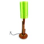 A retro copper and beech table lamp, with a lime green spun cylindrical shade, 71cm high.