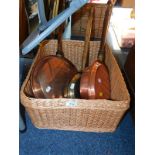 Three copper and brass bed warming pans, together with a wicker basket. (4)