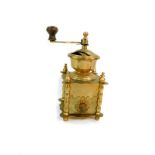 A Continental brass coffee grinder, 13cm wide.