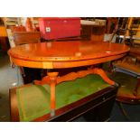 A mahogany coffee table, with oval top raised on a twin pedestal base, 48cm high, 124cm wide, 77cm