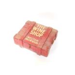 A red painted ammo box, with a sectioned interior, painted to the lid 'The Wine Shop Melton