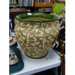 A pottery jardiniere, green glaze, sgraffito flowers and scrolling leaves, 37cm Diameter and 34cm