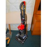 A Dyson DC33 upright vacuum cleaner.