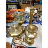 A Hinks No 1 brass oil lamp base, two further brass oil lamp bases and a Corinthian column table