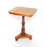 A Regency mahogany tilt top occasional table, raised on a turned fluted and leaf carved column, over