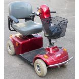 A Free Rider four wheeled mobility scooter, with adjustable seat, key and battery charger, 102cm