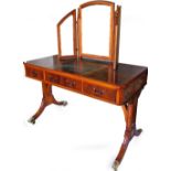 A 20thC yew wood dressing table, the canted top raised above three frieze drawers, on fluted sabre