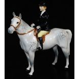 A Beswick black jacketed huntswoman on grey horse, 23cm high. (AF)